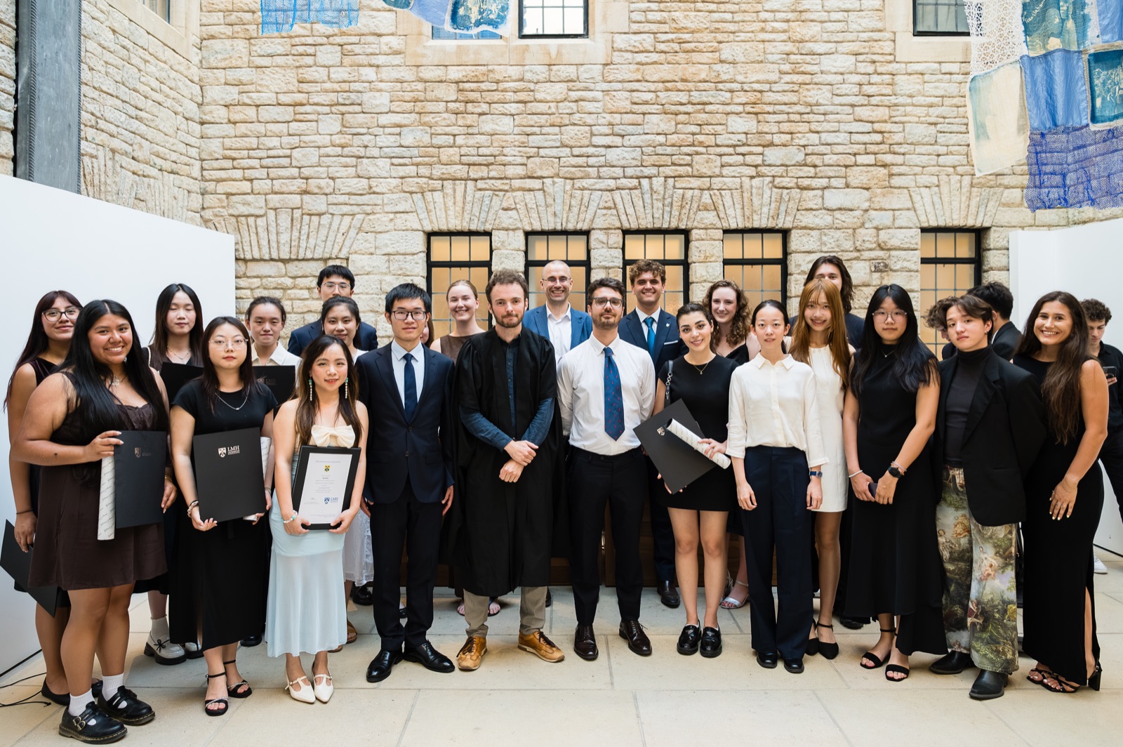 Group portrait of LMH Summer Programmes graduates and teaching staff at Rhodes House